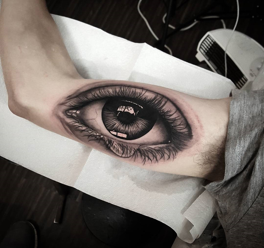 realistic eye guys arm tattoo